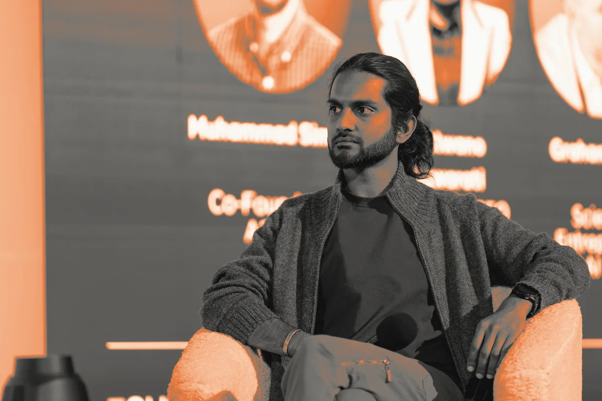 Keshav Mohabir seated on the Founders at Work Summit panel, listening to a fellow speaker
